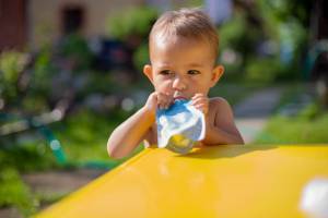 Child eating from squeeze pouch